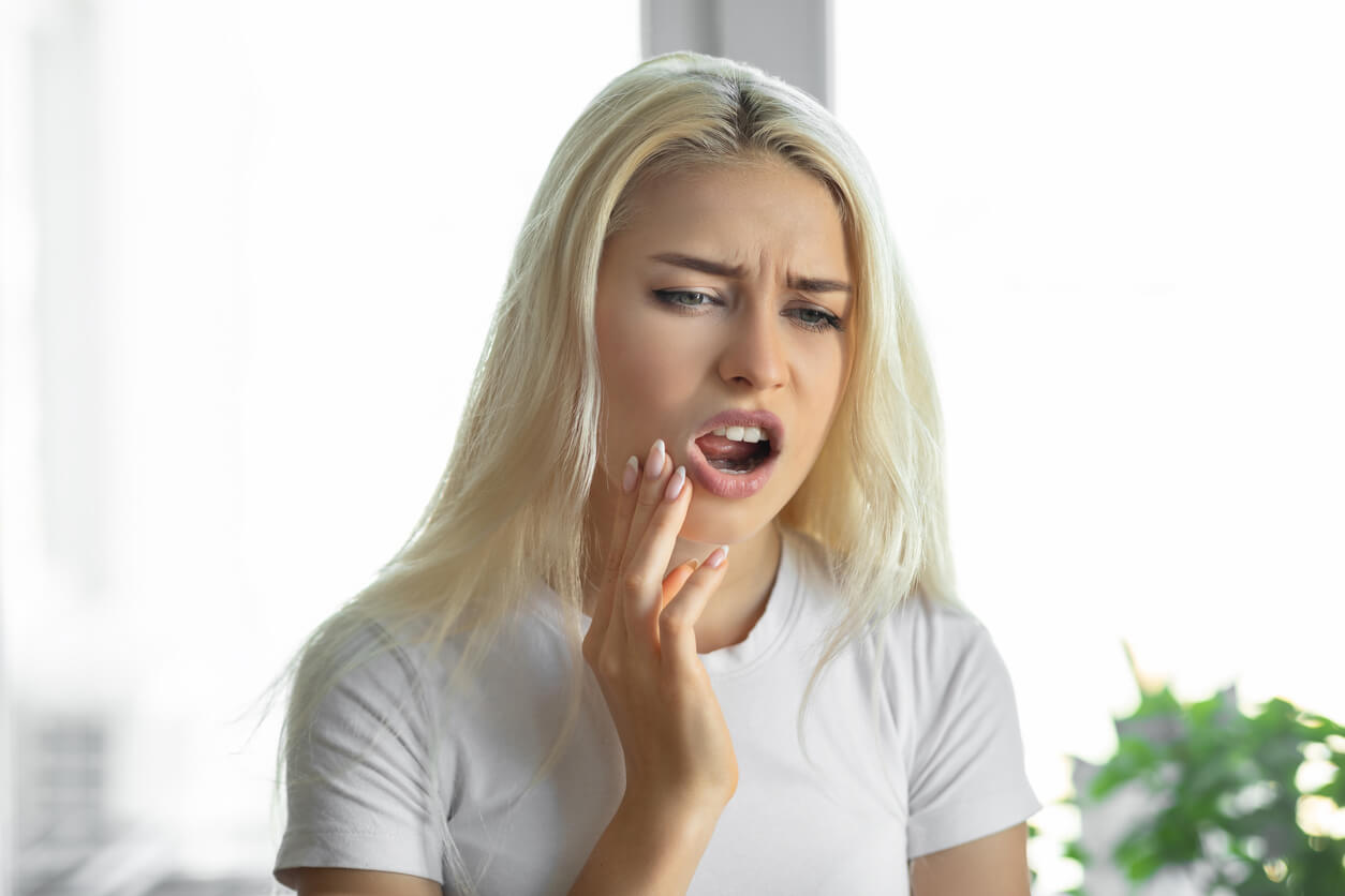 Unhappy woman suffering from tooth and jaw pain